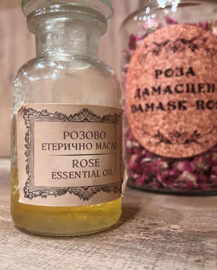 Rose essential oil and dried rose petals – A beautiful bottle of Bulgarian rose essential oil alongside another bottle filled with dried rose petals.