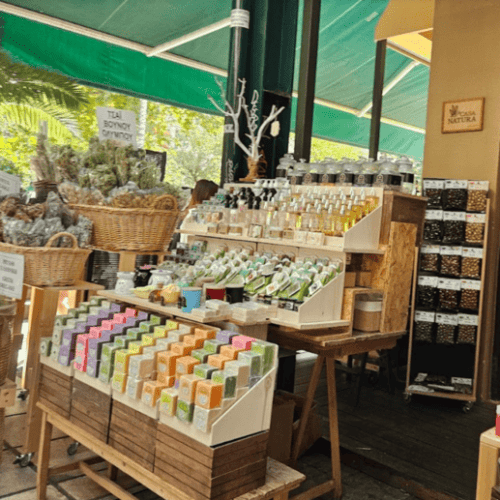 A market stall filled with traditional Greek herbs, olives, and handmade soaps, reflecting the region’s rich flavors and aromas.