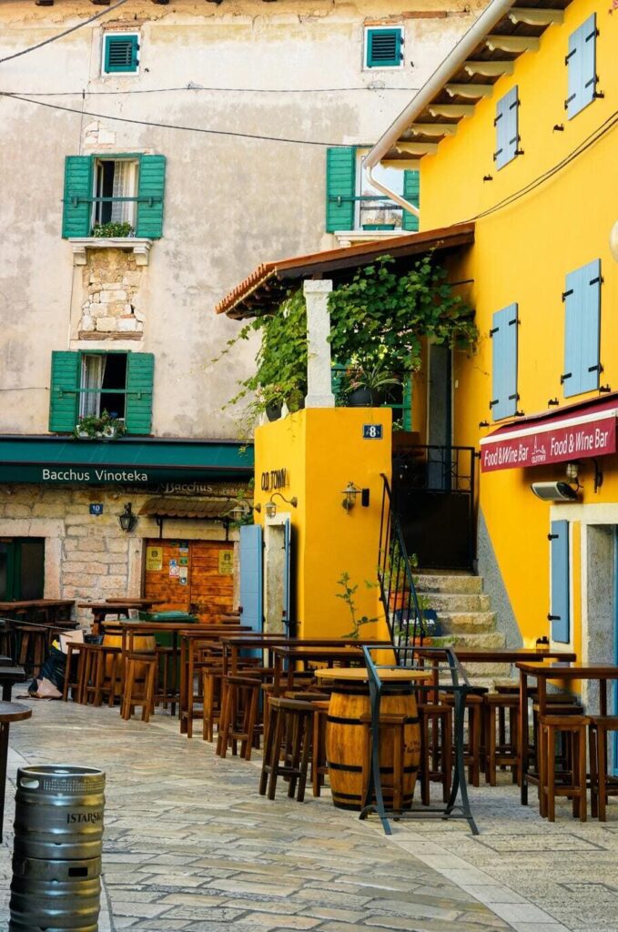 Charming cobblestone streets and traditional yellow medieval houses in a small Istrian town.