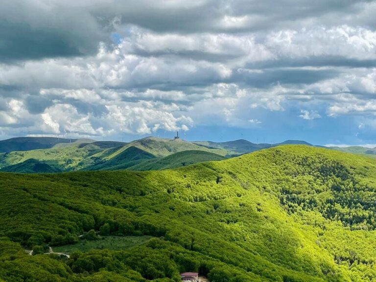 Scenic view of the Balkan Mountains with lush green valleys and rugged peaks under a clear blue sky.