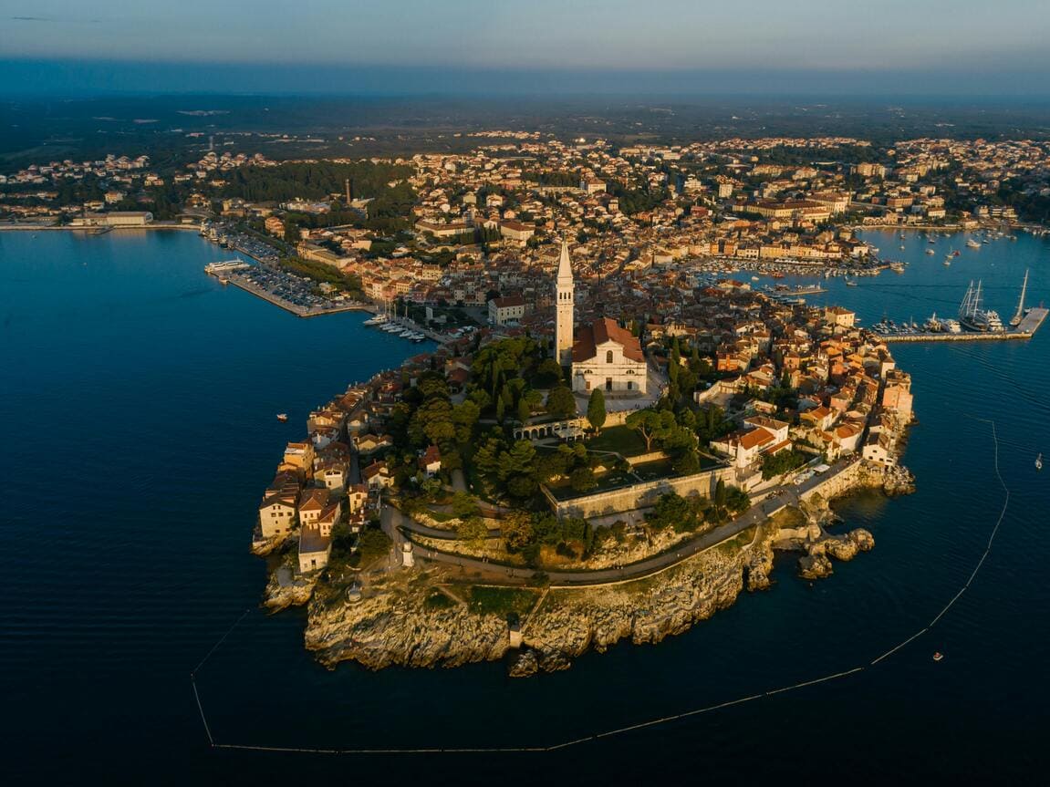 Aerial view of Rovinj, the "Pearl of Istria," with its stunning coastline and deep blue Adriatic Sea.