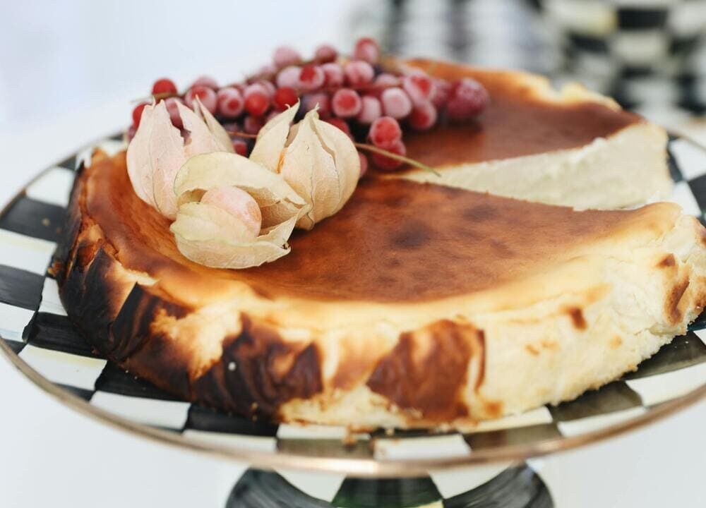 A plate of indulgent San Sebastian cheesecake with a beautifully caramelized top and creamy, rich interior.