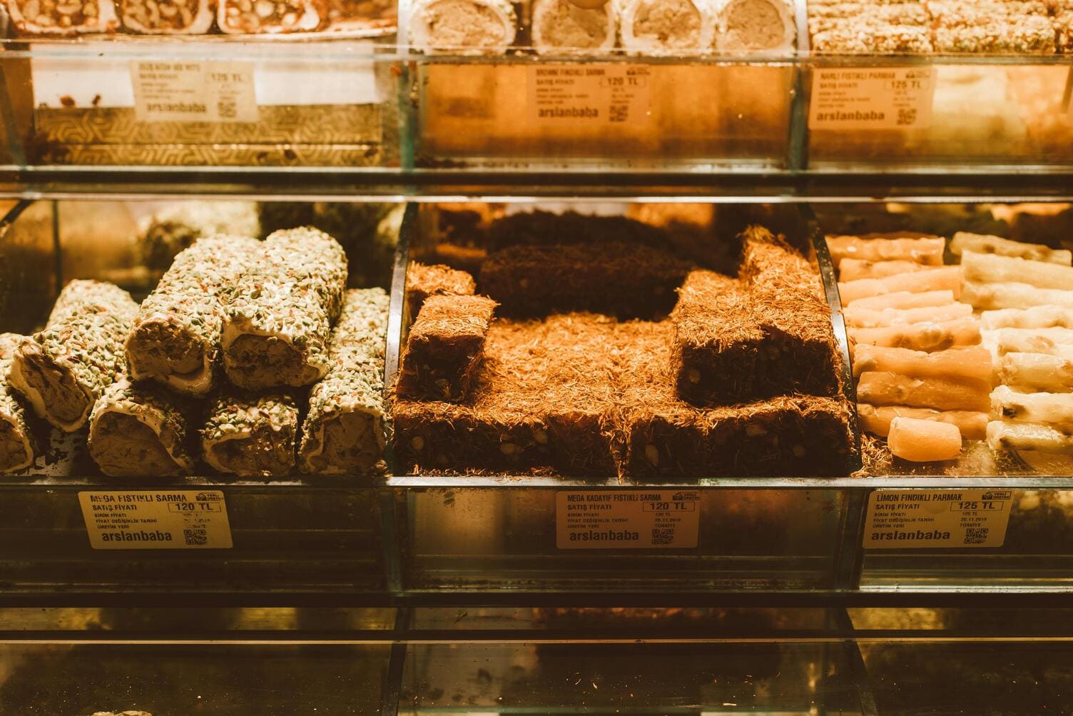 Turkish shop displaying a variety of Turkish delights in different flavors, showcasing colorful cubes of this traditional confectionery dusted with powdered sugar and arranged in an inviting display.