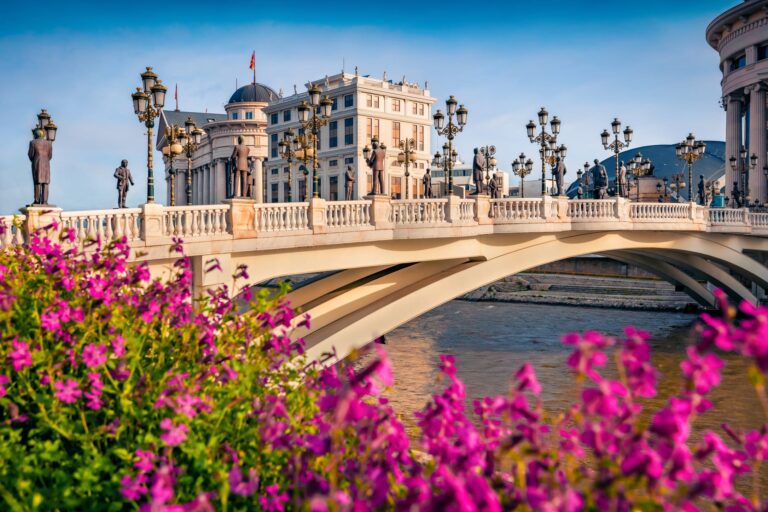 Scenic view of Skopje, the capital of North Macedonia, featuring the Stone Bridge and grand neoclassical architecture in the city center.