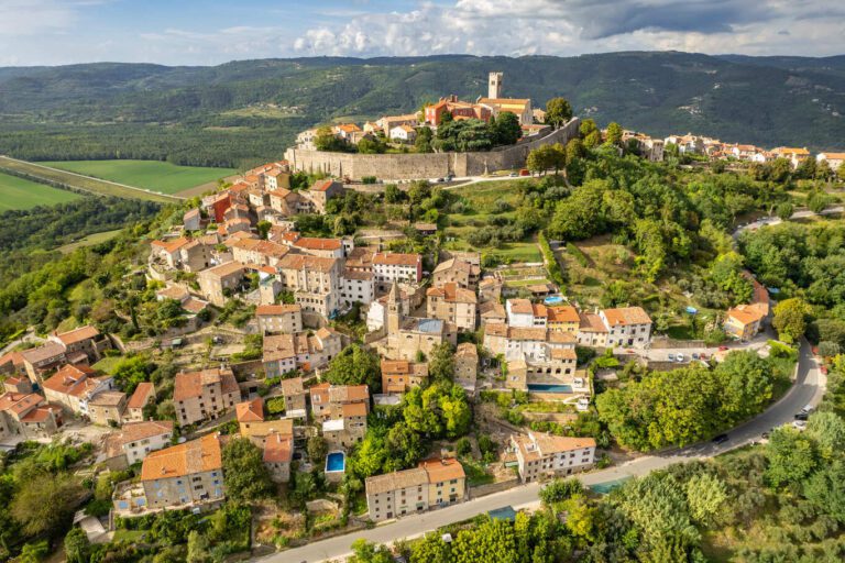 Aerial view of Motovun – Another perspective of the hilltop town, surrounded by green vineyards and forests.