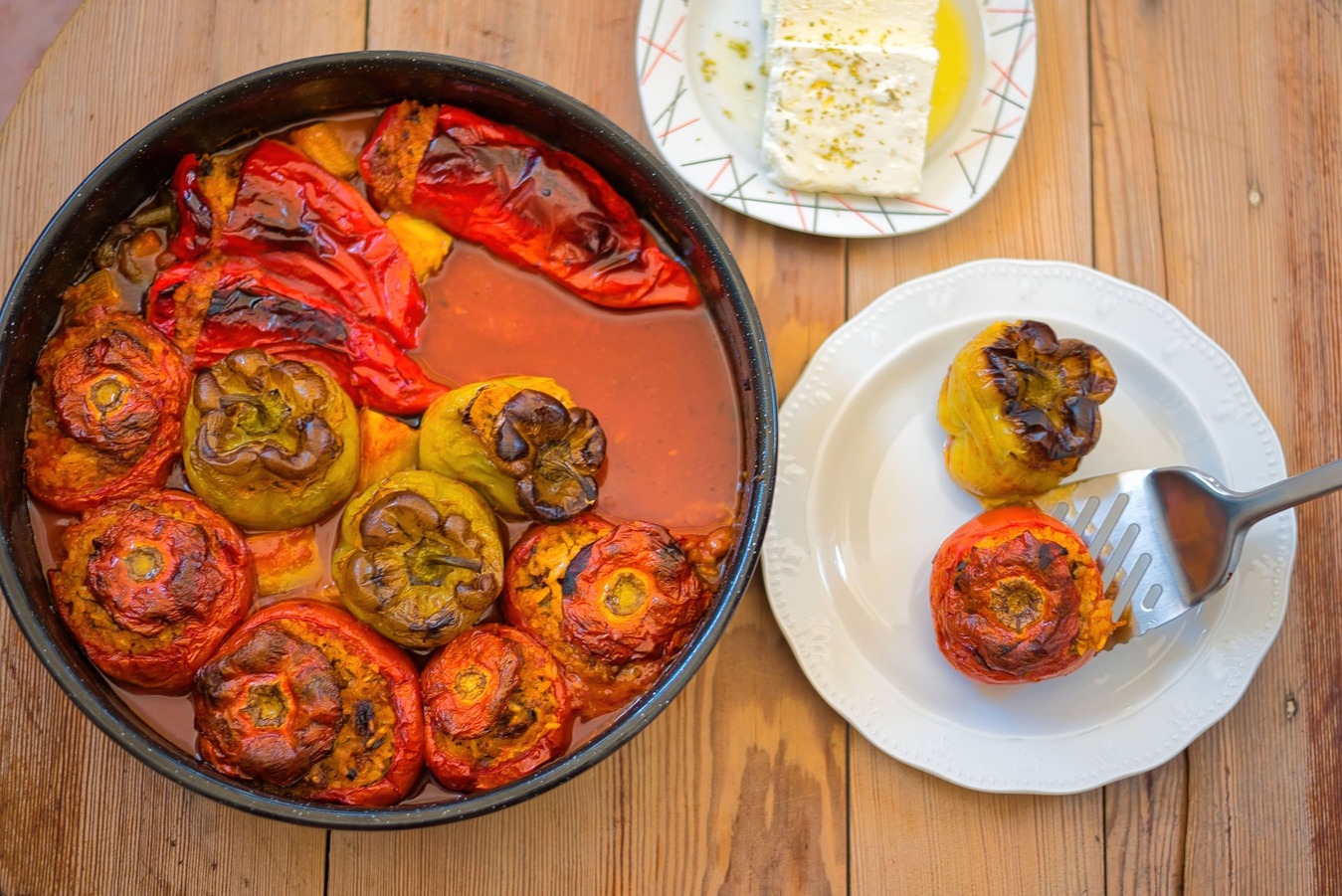 Juicy, oven-baked tomatoes filled with a flavorful mixture of rice, herbs, and spices, a classic dish from Greek cuisine known as Gemista.