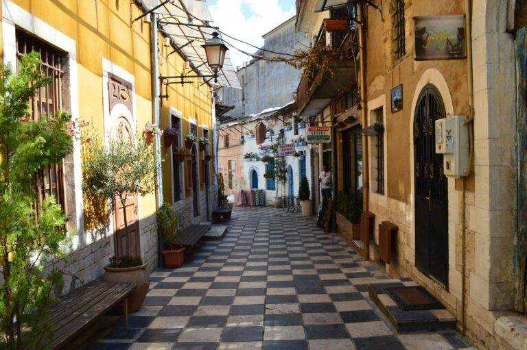 Scenic alleyway in Ioannina with tiled pathways and colorful traditional buildings. Ioannina is somewhat of a hidden destination in Greece's epic North.