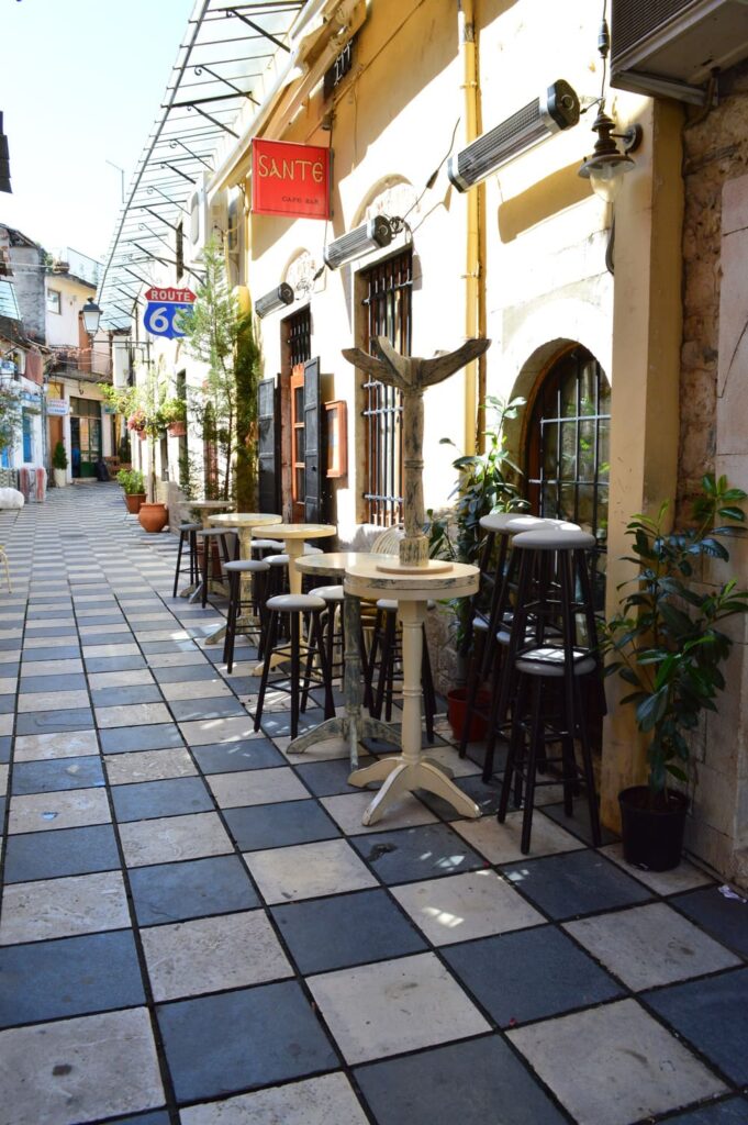 Scenic alleyway in Ioannina with tiled pathways and a beautiful cafeteria on the side.