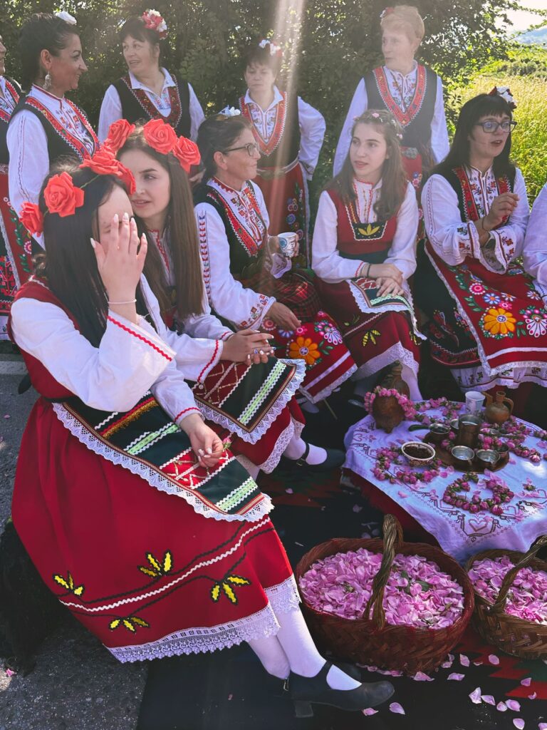 A group of female dancers in traditional Bulgarian attire performs in the Rose Valley, seen on our One-Day Rose Festival Tour.